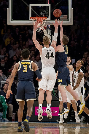 Zavier Simpson (3) and Jon Teske (15)
