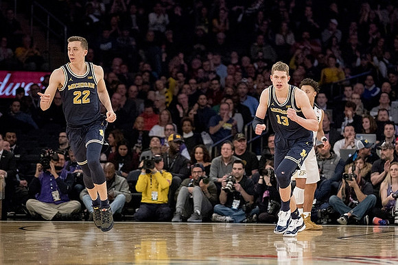 Duncan Robinson (22) and Moritz Wagner (13)