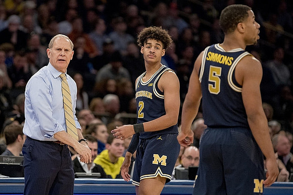 John Beilein, Jordan Poole (2), and Jaaron Simmons (5)