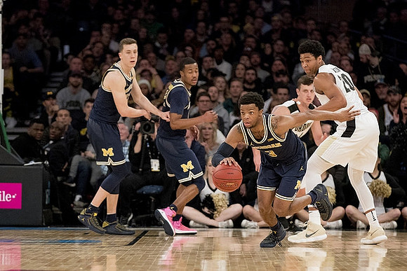 Duncan Robinson (22), Muhammad-Ali Abdur-Rahkman (12), and Zavier Simpson (3)