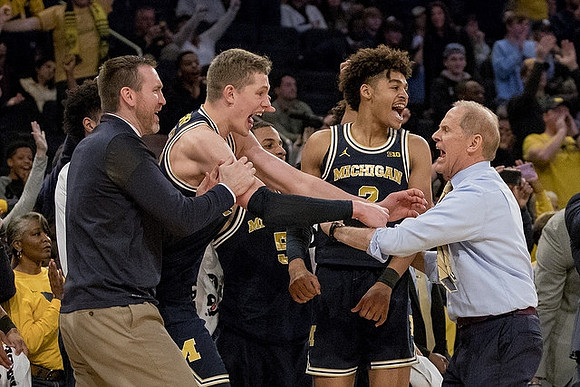 Moritz Wagner (13), Ibi Watson (23), and John Beilein