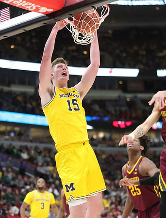 Zavier Simpson (3) and Jon Teske (15)