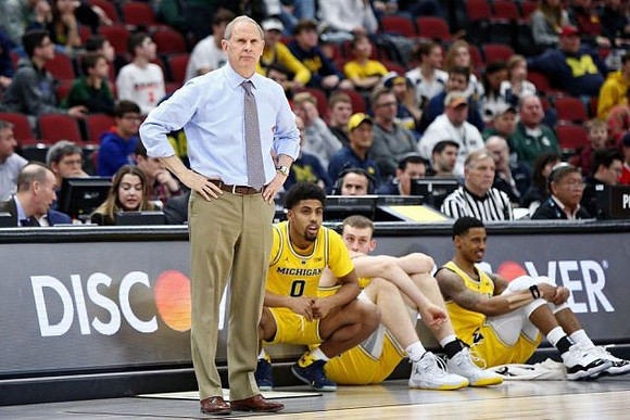 John Beilein, David DeJulius (0), Austin Davis (51), and Charles Matthews (1)