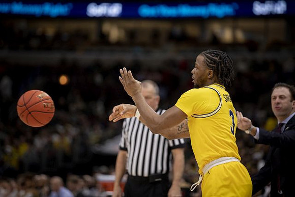 Zavier Simpson (3) and Minnesota Head Coach Richard Pitino