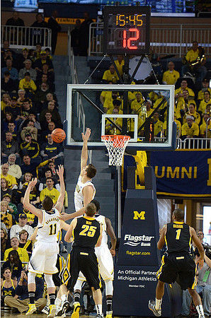 Nik Stauskas (11), Mitch McGary (4), and Tim Hardaway Jr. (10)