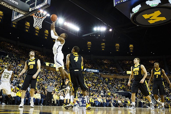 Caris LeVert (23), Glenn Robinson III (1), and Spike Albrecht (2)