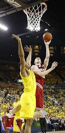 Jon Horford (15) and Trey Burke (3)