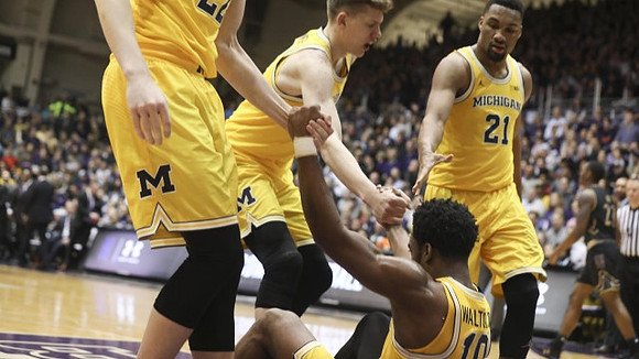 Duncan Robinson (22), Moritz Wagner (13), Zak Irvin (21), and Derrick Walton Jr. (10)