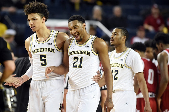D.J. Wilson (5), Zak Irvin (21), and Muhammad-Ali Abdur-Rahkman (12)
