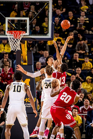 Derrick Walton Jr. (10), Mark Donnal (34), and D.J. Wilson (5)