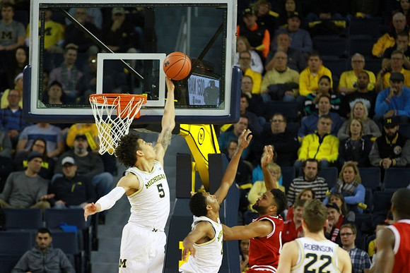 D.J. Wilson (5), Zak Irvin (21), and Duncan Robinson (22)