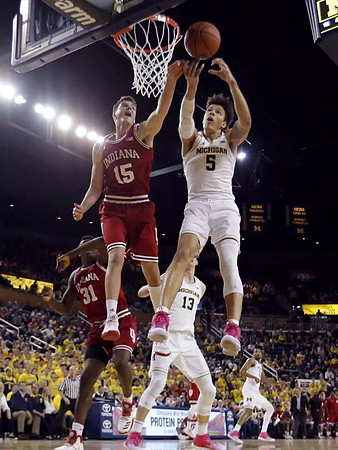D.J. Wilson (5), Moritz Wagner (13), and Zak Irvin (21)