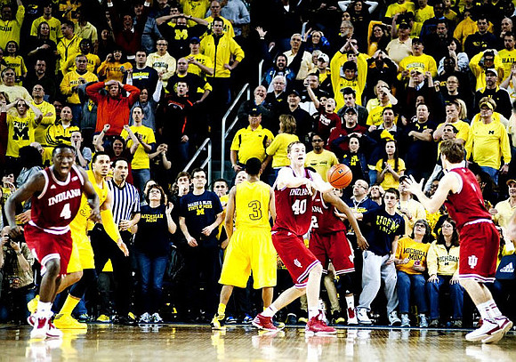 Jordan Morgan (52) and  Trey Burke (3)