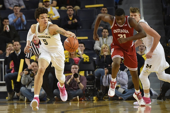 D.J. Wilson (5) and Moritz Wagner (13)