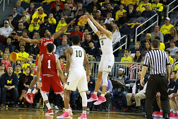 Derrick Walton Jr. (10) and D.J. Wilson (5)