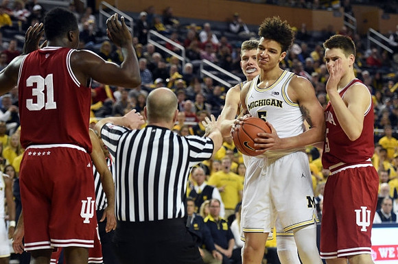 Moritz Wagner (13) and D.J. Wilson (5)