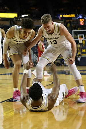 D.J. Wilson (5), Derrick Walton Jr. (10), and Moritz Wagner (13)