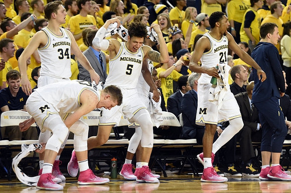 Mark Donnal (34), Moritz Wagner (13), D.J. Wilson (5), Zak Irvin (21), and Andrew Dakich (11)