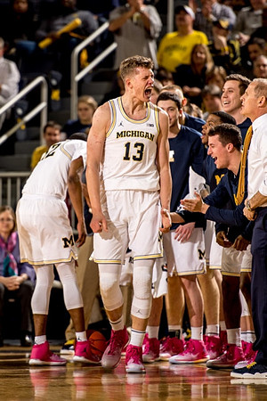 Moritz Wagner (13) and Michigan Team