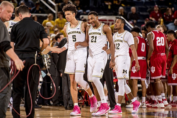 D.J. Wilson (5), Zak Irvin (21), and Muhammad-Ali Abdur-Rahkman (12)