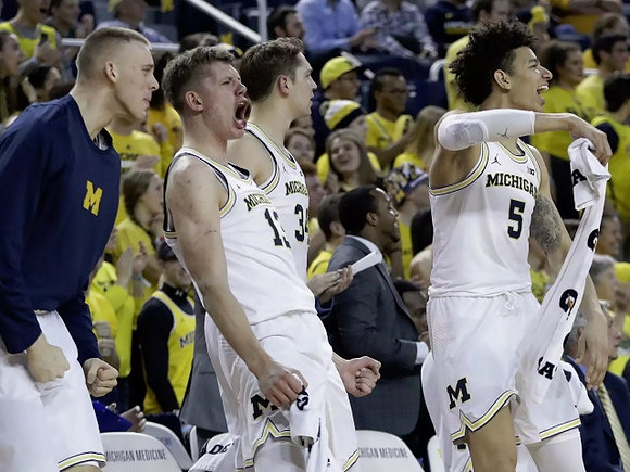 Austin Davis (51), Moritz Wagner (13), Mark Donnal (34), and D.J. Wilson (5)