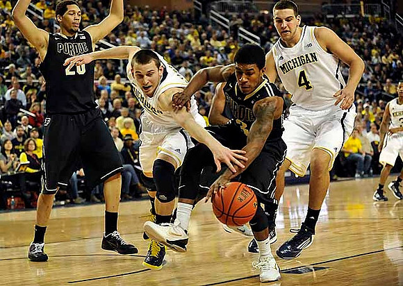 Nik Stauskas (11) and Mitch McGary (4)