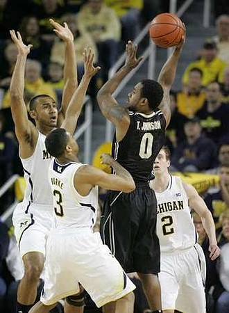 Caris LeVert (23), Jon Horford (15), and Spike Albrecht (2)
