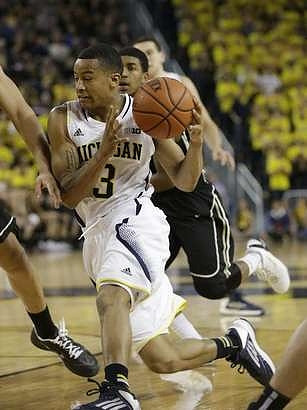 Trey Burke (3) and Nik Stauskas (11)