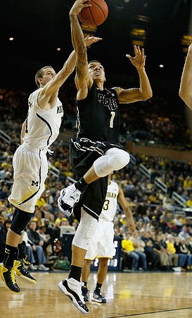 Nik Stauskas (11) and Trey Burke (3)