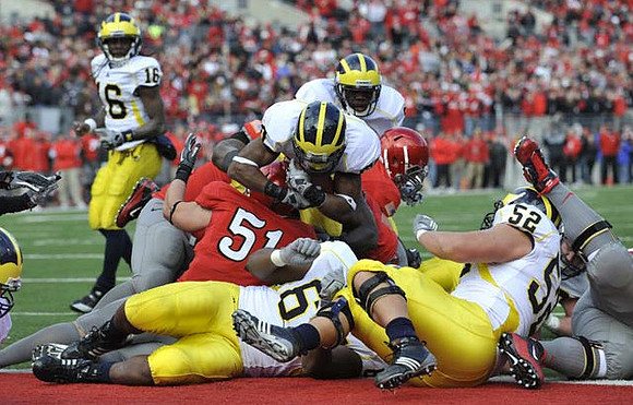 Denard Robinson (16), Michael Shaw (20), Patrick Omameh (65), and Stephen Schilling (52)