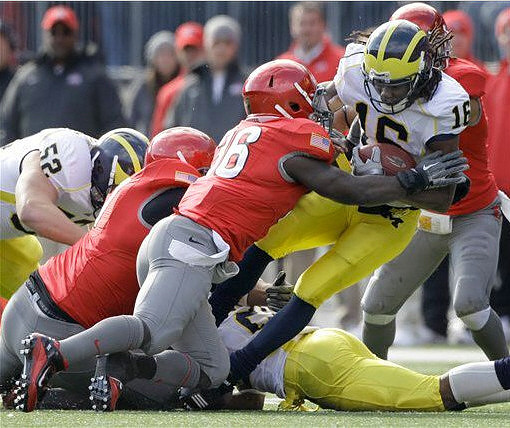 Stephen Schilling (52) and Denard Robinson (16)