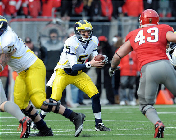Taylor Lewan (77) and Tate Forcier (5)