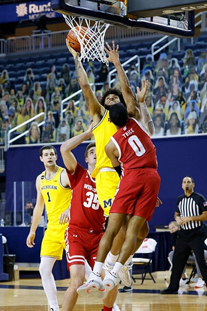 Hunter Dickinson (1) and Isaiah Livers (2)