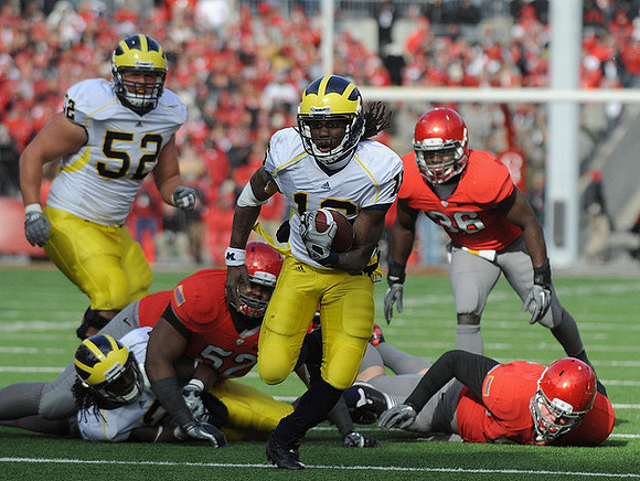 Stephen Schilling (52) and Denard Robinson (16)