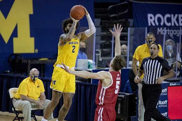 Isaiah Livers (2), Phil Martelli, and Juwan Howard