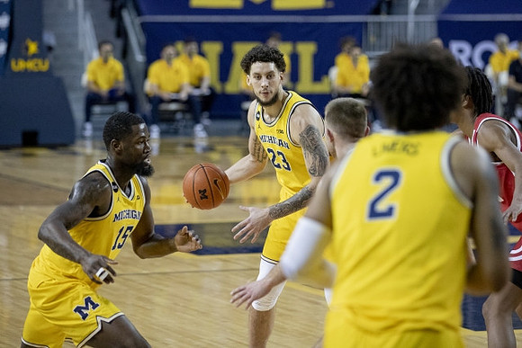 Chaundee Brown Jr. (15), Brandon Johns Jr. (23), and Isaiah Livers (2)