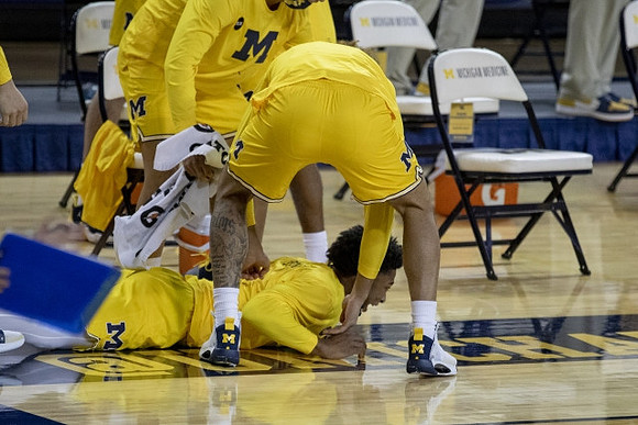 Jace Howard (25) and Michigan Team