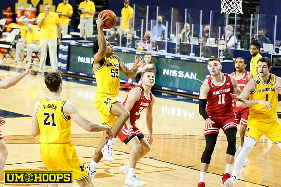 Franz Wagner (21), Eli Brooks (55), Hunter Dickinson (1), and Mike Smith (12)
