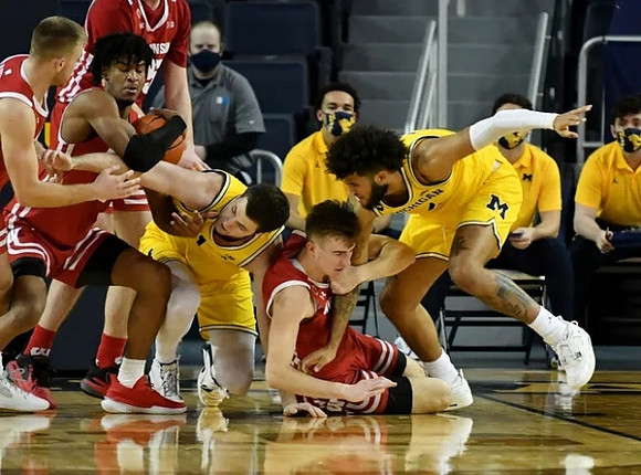 Hunter Dickinson (1) and Isaiah Livers (2)