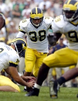 Garrett Rivas (38), Matt Gutierrez (12), and Pierre Woods (99)