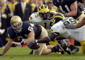 Pierre Woods (99) and Steve Breaston (15)