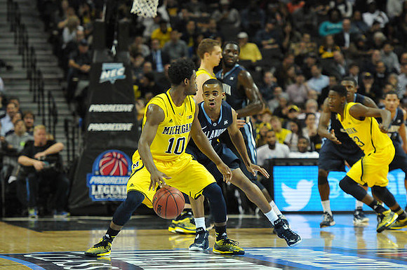 Derrick Walton Jr. (10), Mark Donnal (34), and Caris LeVert (23)
