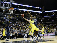 Spike Albrecht (2), Zak Irvin (21), and Caris LeVert (23)