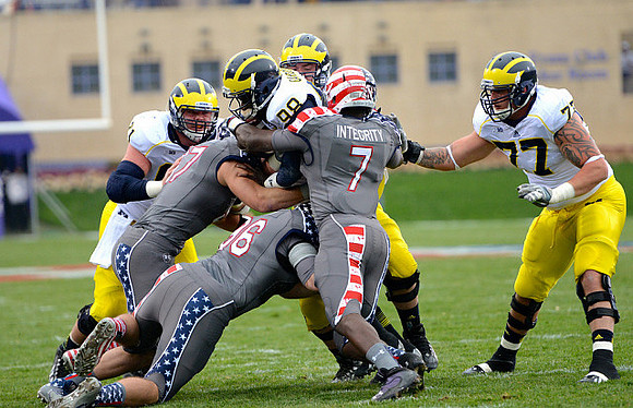 Graham Glasgow (61), Devin Gardner (98), and Taylor Lewan (77)