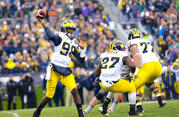 Devin Gardner (98), Derrick Green (27), and Taylor Lewan (77)
