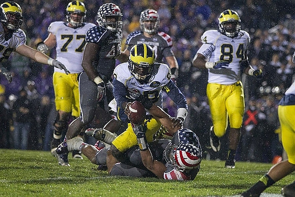 Taylor Lewan (77), Devin Gardner (98), and A.J. Williams (84)