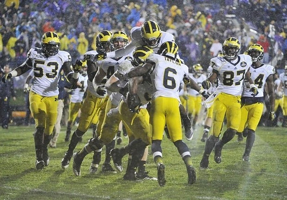 Mario Ojemudia (53), Raymon Taylor (6), Devin Funchess (87), and Delano Hill (44)