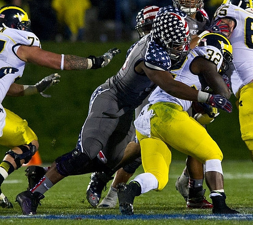 Taylor Lewan (77), De'Veon Smith (32), and Kyle Bosch (65)