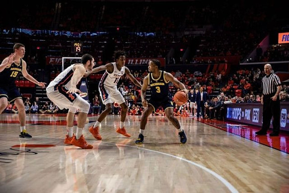 Jon Teske (15) and Zavier Simpson (3)
