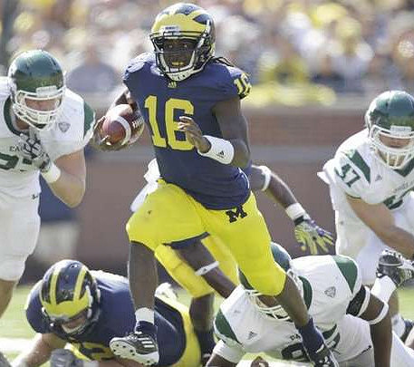 Mark Huyge (72) and Denard Robinson (16)
